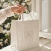 Luxury white embossed paper bag with handles for premium packaging