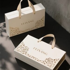 Luxury book style magnetic gift packaging box with handle and floral cutout design