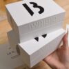 Luxury rigid gift box made from specialty paper with embossed logo and minimalist design