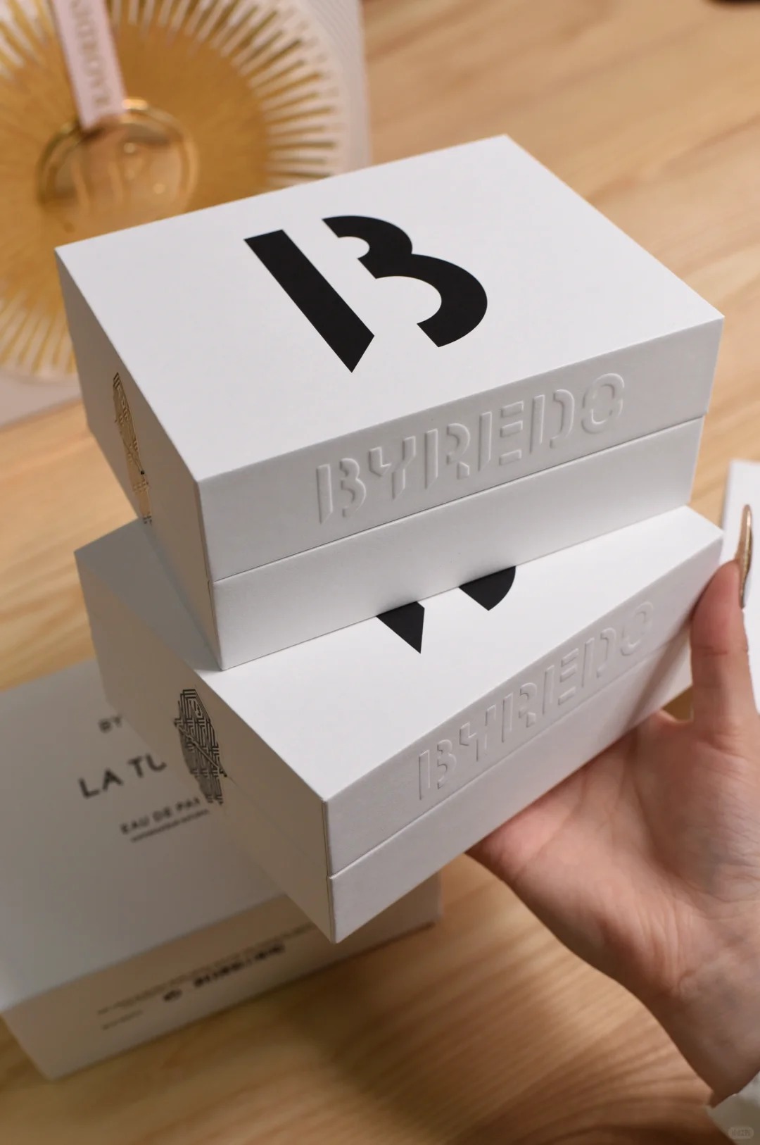 Luxury rigid gift box made from specialty paper with embossed logo and minimalist design