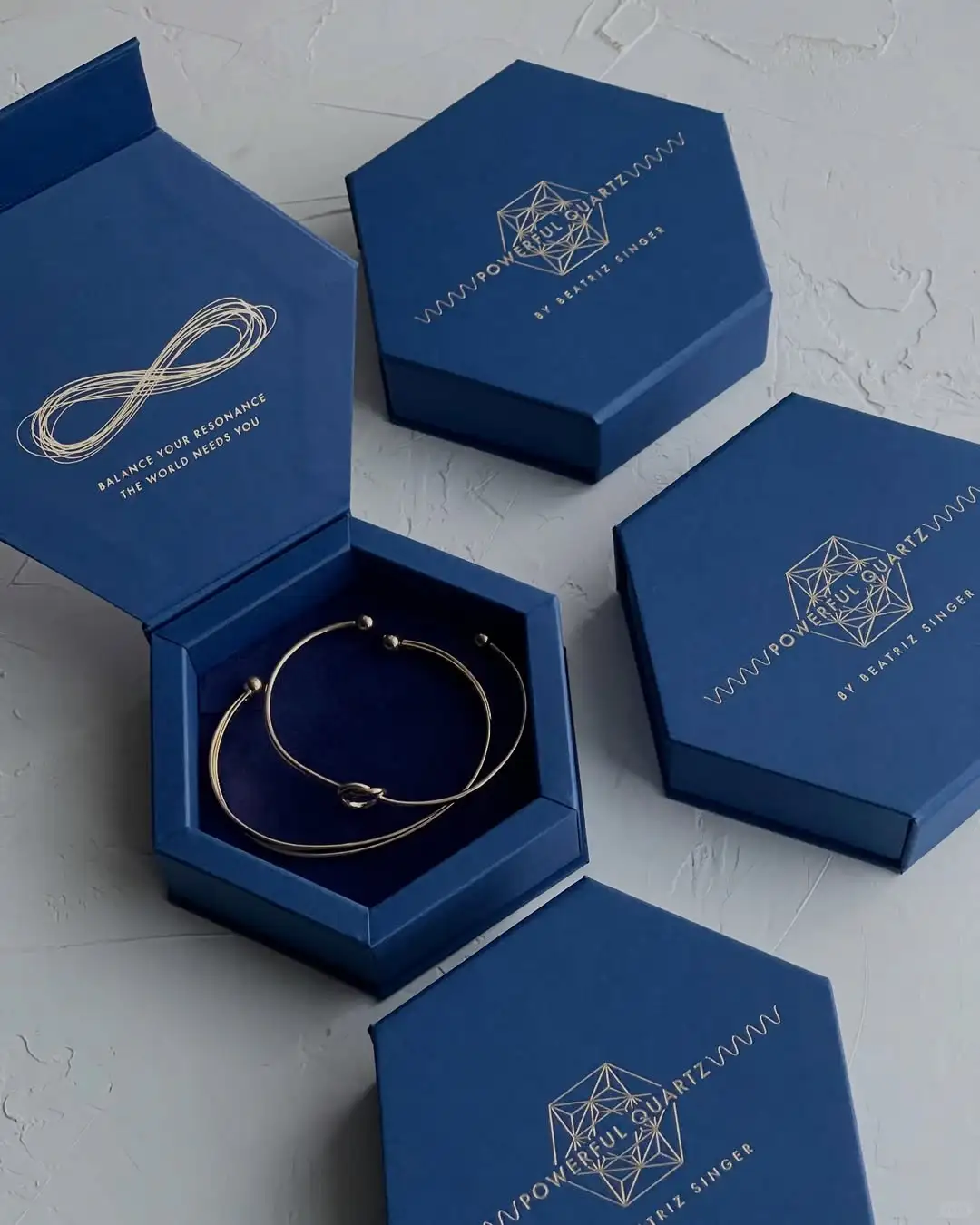 Luxury blue hexagon jewelry box with gold foil logo and velvet insert for bracelet and necklace packaging